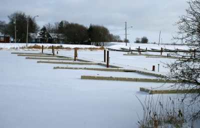 Floating marina dock surrounded by winter snow